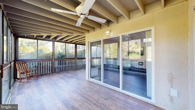 unfurnished sunroom featuring ceiling fan