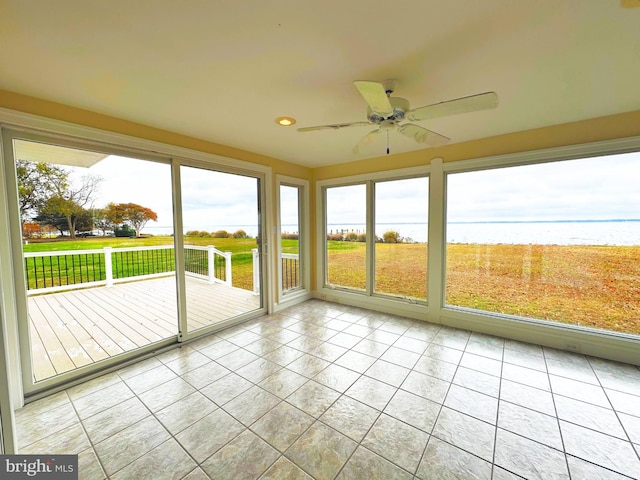 unfurnished sunroom with ceiling fan