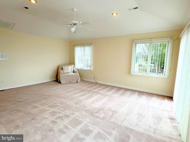 unfurnished room with ceiling fan, light colored carpet, and vaulted ceiling