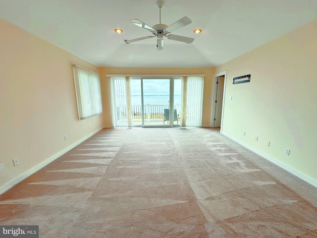 carpeted empty room featuring lofted ceiling and ceiling fan