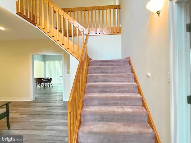 stairs featuring hardwood / wood-style flooring