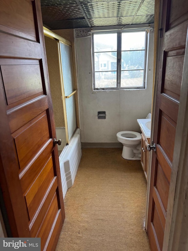 full bathroom with vanity, enclosed tub / shower combo, and toilet