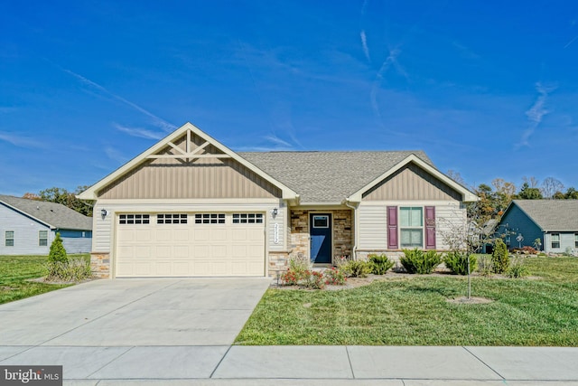 view of front of house with a front yard and a garage