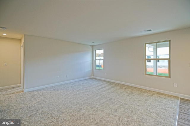 carpeted empty room featuring a healthy amount of sunlight