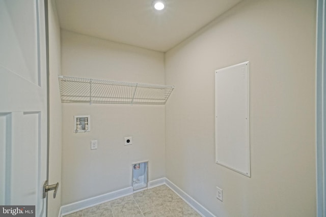 laundry room featuring washer hookup, electric dryer hookup, and light tile patterned flooring