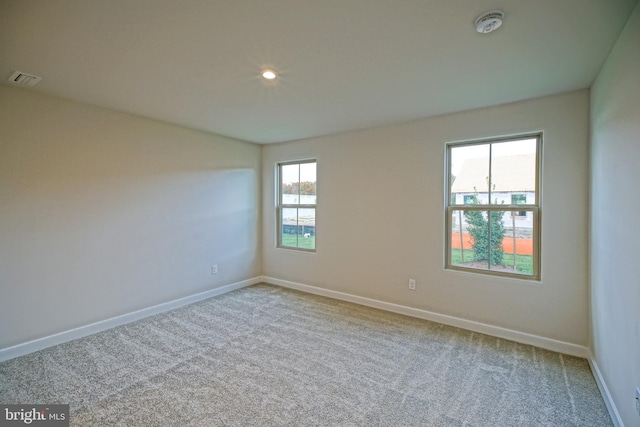 unfurnished room featuring light colored carpet