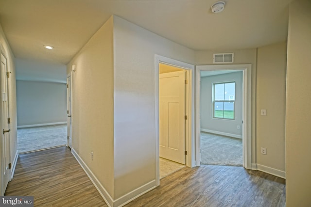 corridor featuring wood-type flooring