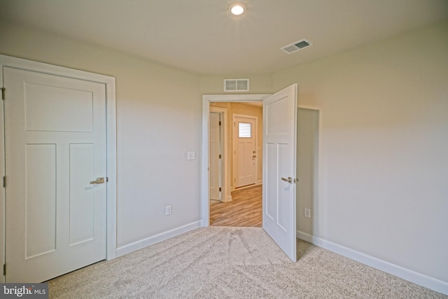 unfurnished bedroom with light carpet