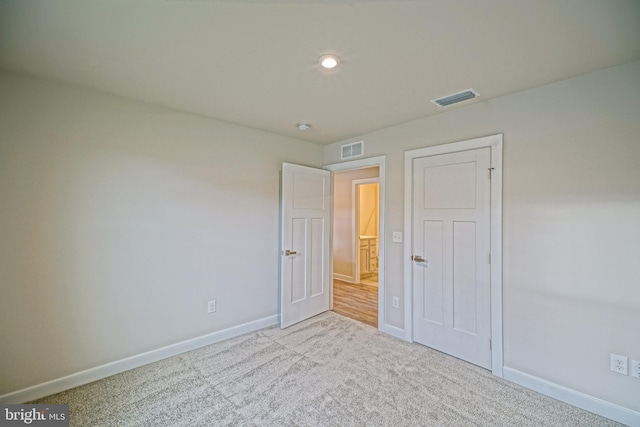 unfurnished bedroom with light carpet