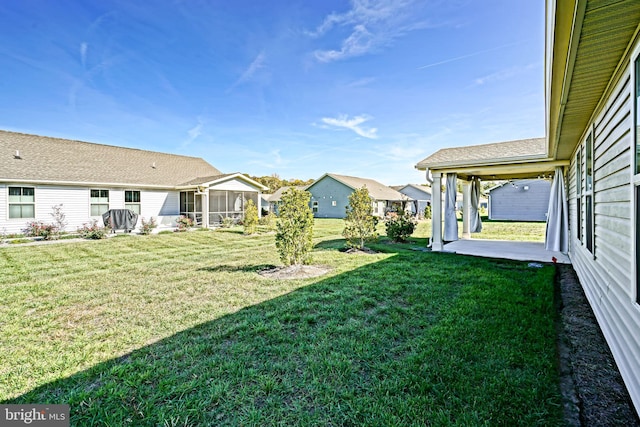 view of yard with a patio area and a sunroom