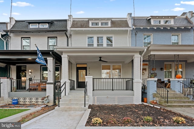 multi unit property featuring ceiling fan and a porch