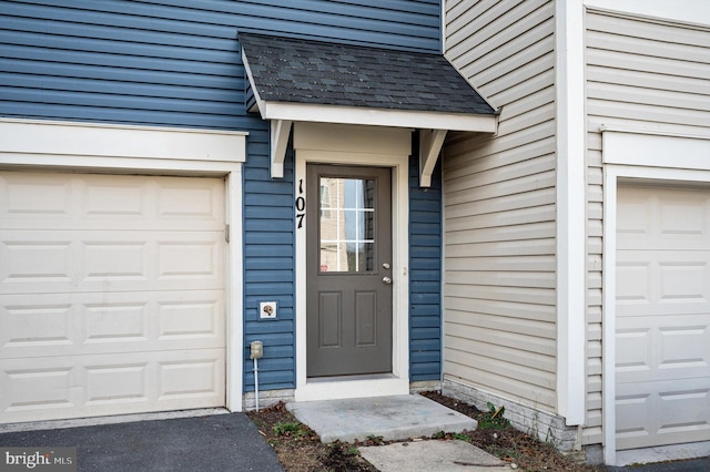 view of exterior entry with a garage