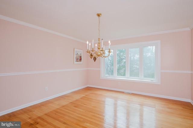 unfurnished room featuring ornamental molding, a chandelier, and light hardwood / wood-style floors