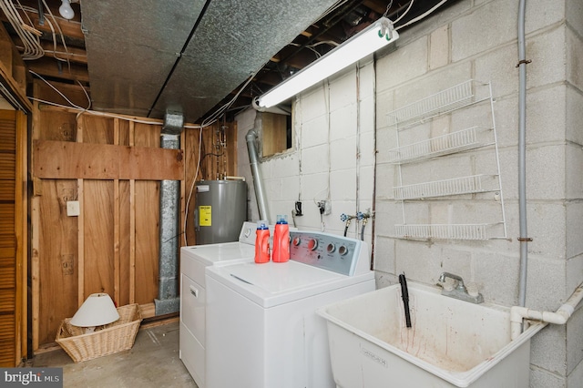 clothes washing area with washing machine and clothes dryer, electric water heater, and sink