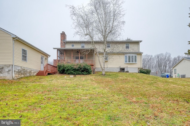 back of house featuring a sunroom, ceiling fan, a yard, central AC unit, and a deck