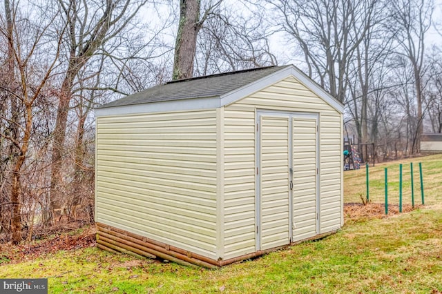 view of outbuilding with a lawn