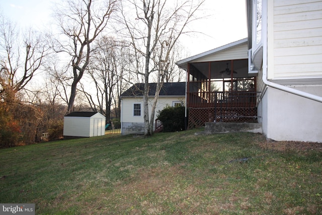 view of yard featuring a storage shed and a sunroom