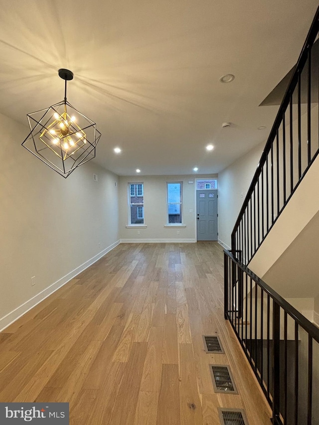 entryway featuring a notable chandelier and light hardwood / wood-style floors