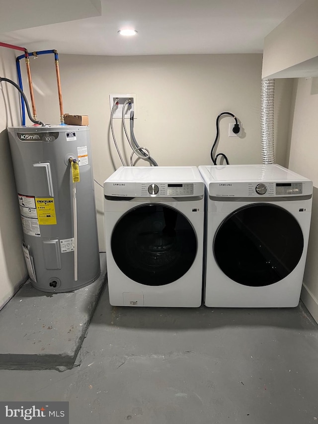 laundry room featuring electric water heater and washer and dryer