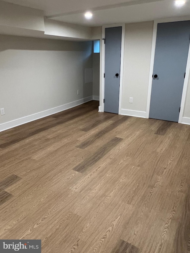 basement with hardwood / wood-style flooring