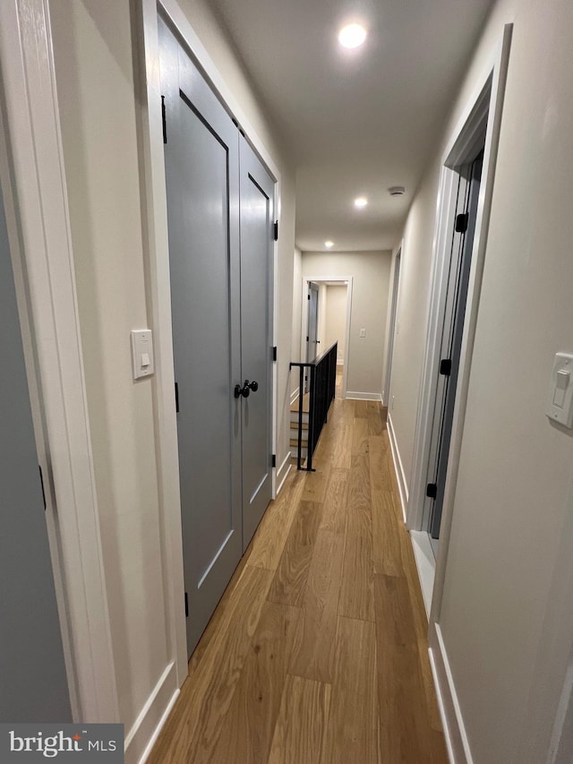 corridor with light hardwood / wood-style flooring