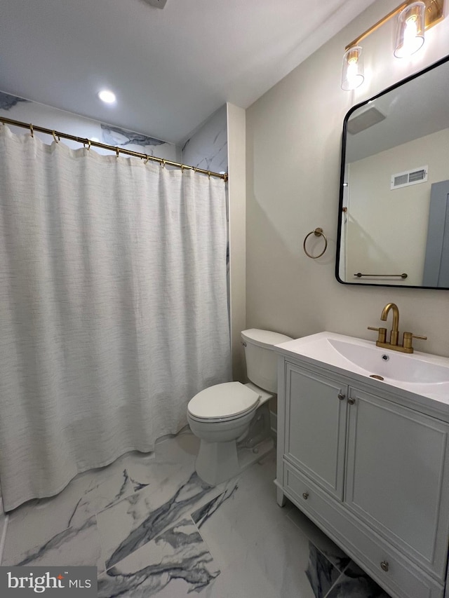 bathroom with vanity, toilet, and walk in shower