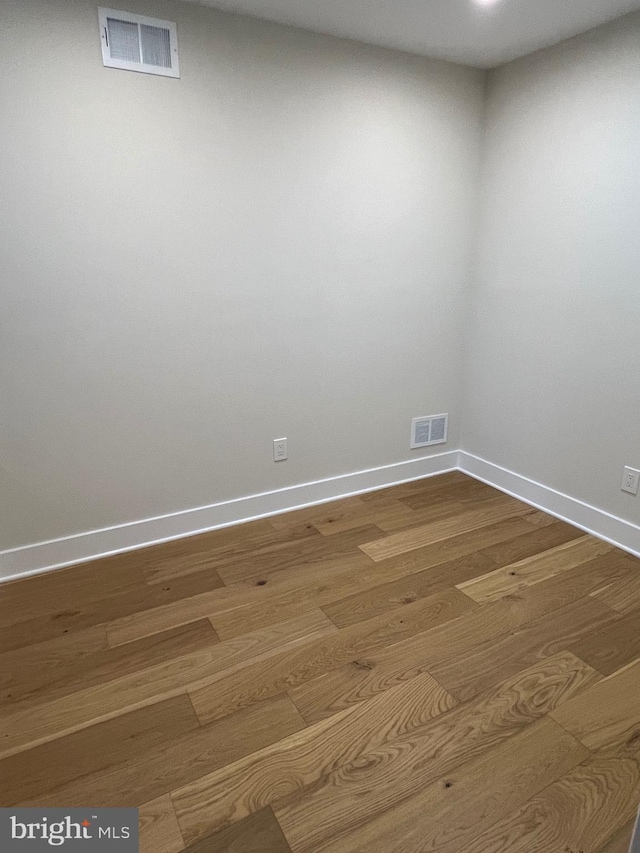 unfurnished room featuring wood-type flooring