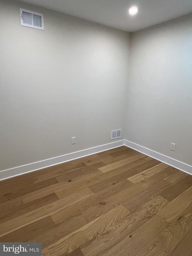 spare room featuring wood-type flooring