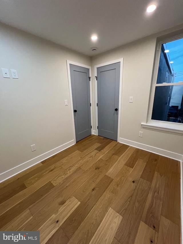 unfurnished room with wood-type flooring