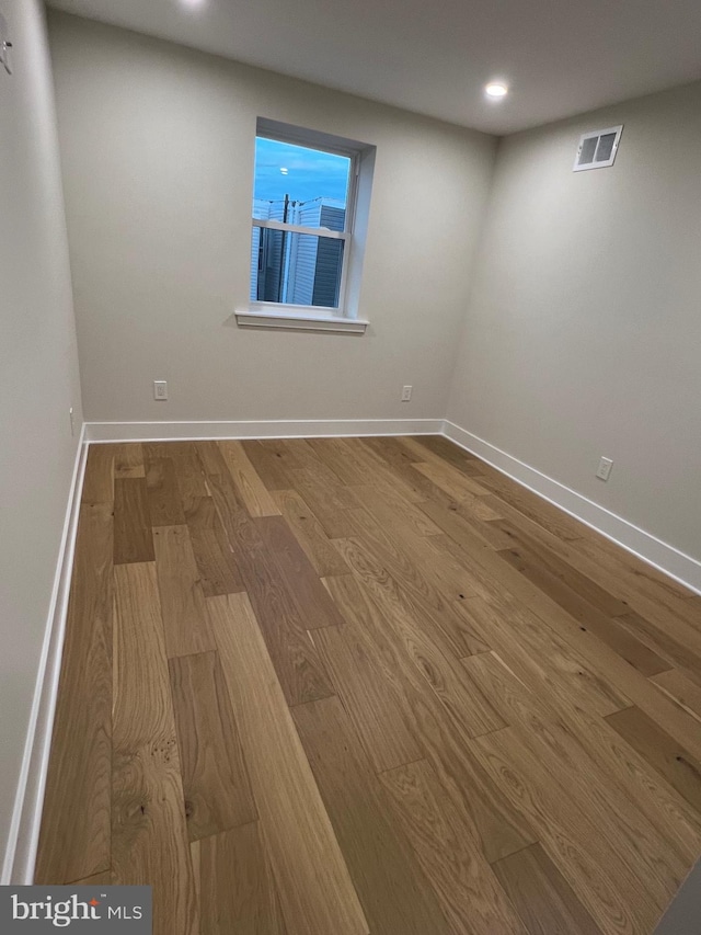 empty room with hardwood / wood-style floors