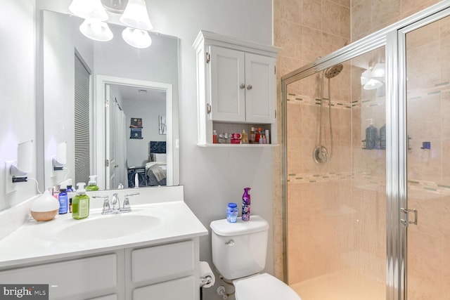 bathroom with vanity, toilet, and an enclosed shower