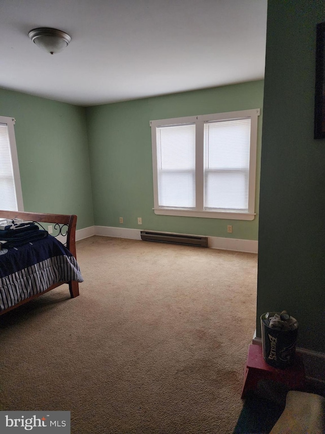 carpeted bedroom featuring a baseboard radiator