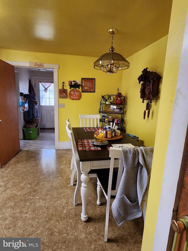 dining area featuring an inviting chandelier