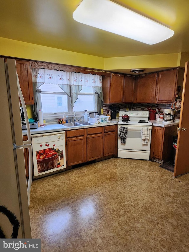 kitchen with decorative backsplash, sink, and white appliances