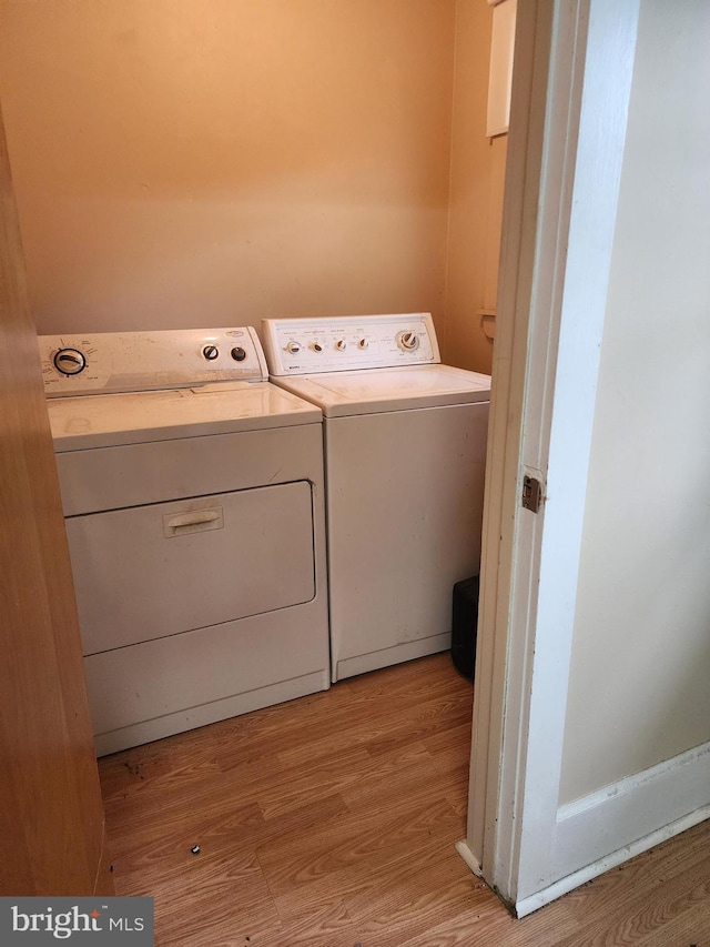 washroom featuring washer and dryer and light hardwood / wood-style floors