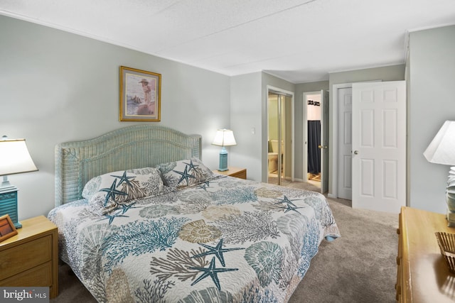 carpeted bedroom featuring ensuite bath