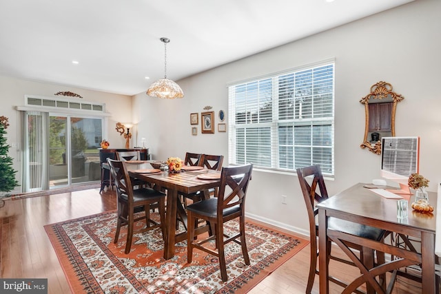 dining space with light hardwood / wood-style floors and plenty of natural light