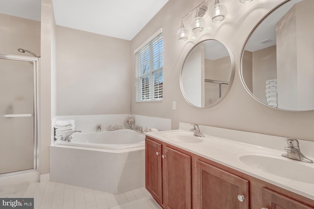 bathroom with tile patterned flooring, vanity, and shower with separate bathtub