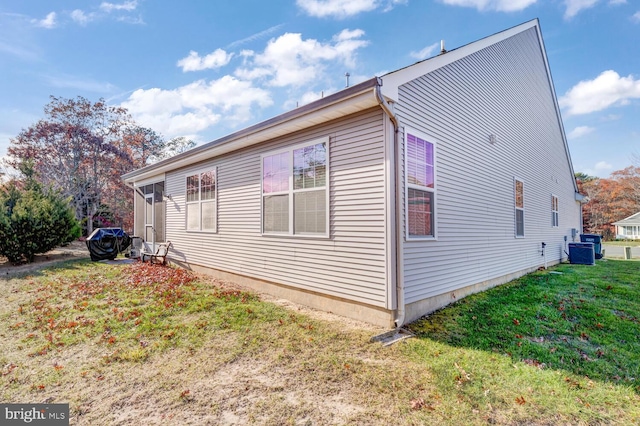 view of side of home with a yard