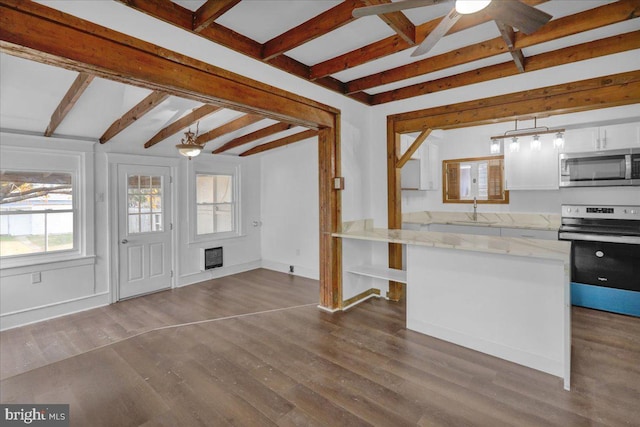 kitchen featuring white cabinets, pendant lighting, stainless steel appliances, and beam ceiling