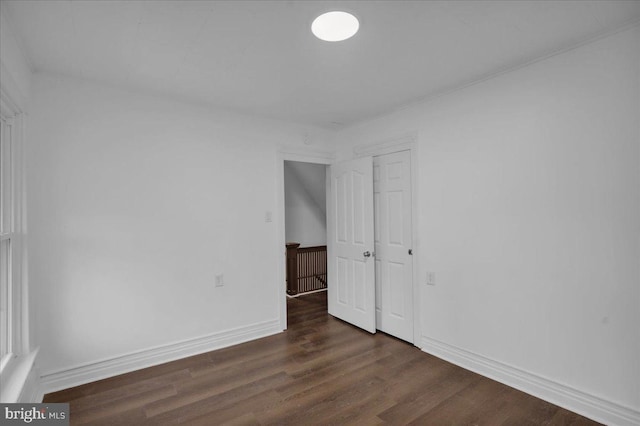 unfurnished room featuring dark hardwood / wood-style flooring