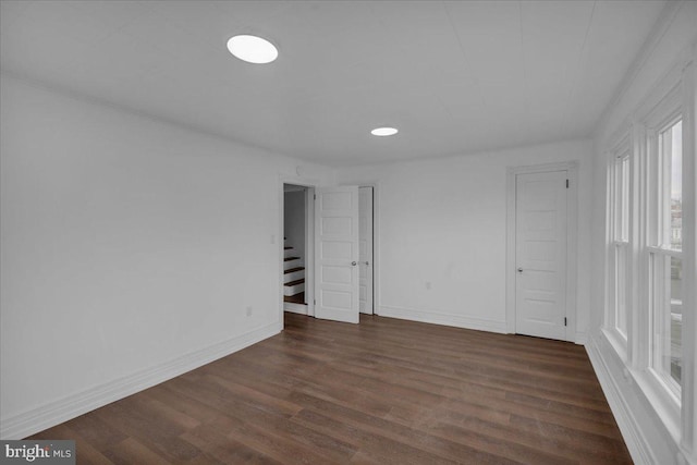 unfurnished room featuring dark wood-type flooring