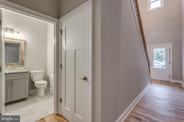 bathroom featuring hardwood / wood-style floors, vanity, and toilet