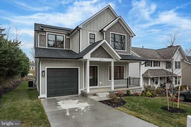 view of front of property featuring a porch, a garage, central air condition unit, and a front yard