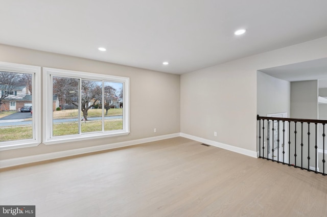 spare room with light hardwood / wood-style floors