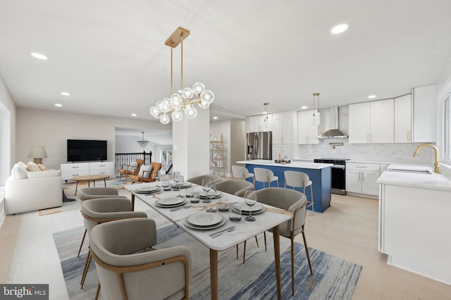 dining room featuring a chandelier, light hardwood / wood-style flooring, and sink