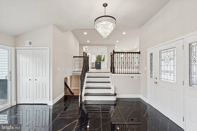 foyer entrance featuring a notable chandelier