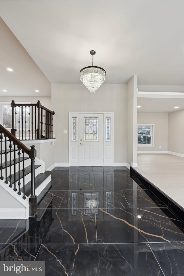 entryway with a chandelier