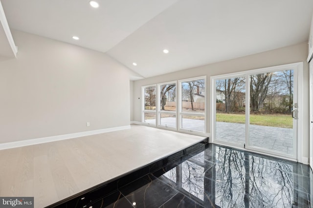 kitchen featuring lofted ceiling, hardwood / wood-style flooring, and a healthy amount of sunlight