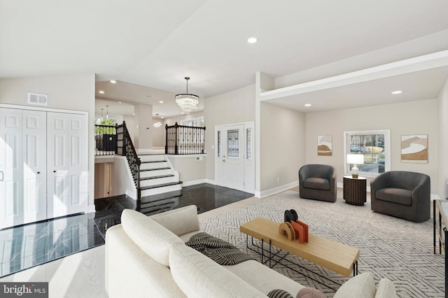 living room with vaulted ceiling and an inviting chandelier